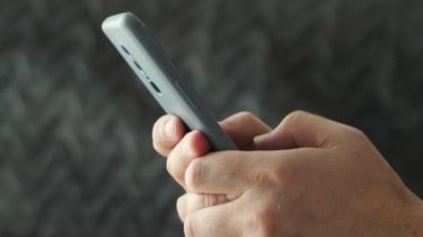 Modern akıllı telefon ellerinde. Telefon ekranında mesaj yazan adam.