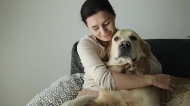 Girl Hugging Golden Retriever Dog Home Smiling Young Woman Petting — Stock Video