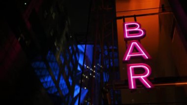 Colourful neon signboard bar lightning and flashing at night city