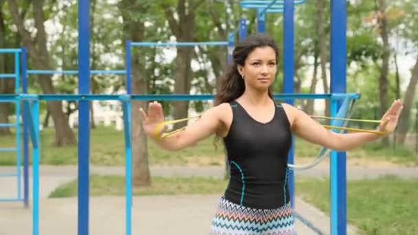 Pretty Girl Elastic Rubber Band Doing Arms Back Workout Outdoors — Video Stock