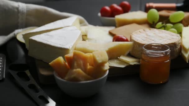 Mix Cheese Nuts Fruits Cheese Plate Wine Appetizer Black Background — Vídeo de stock