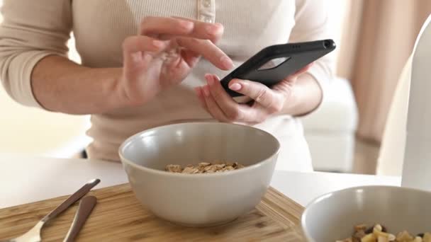 Girl Oatmeal Bowl Smartphone Hands Checking Social Media News Cereal — Stockvideo