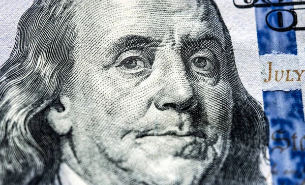 Portrait of president of USA Benjamin Franklin on one hundred dollars banknote, close up view