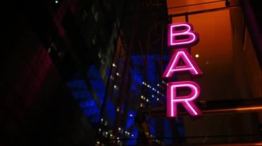 Colourful neon signboard bar lightning and flashing at night city