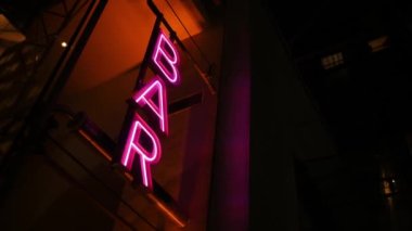 Colourful neon signboard bar lightning and flashing at night city