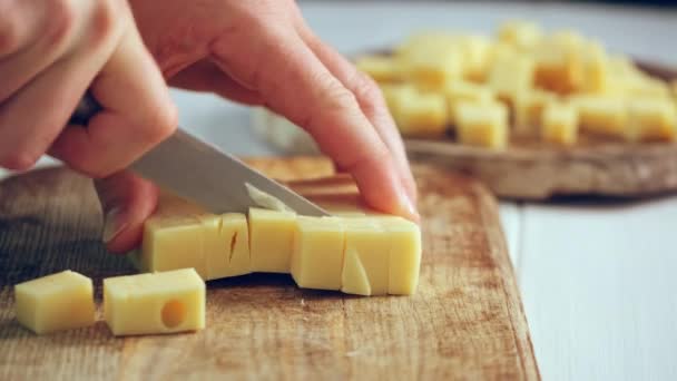 Woman Chops Cheese Cubes Wooden Board — Stock Video