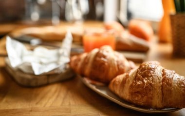 French breakfast with croissants and brie cheese at sunny kitchen