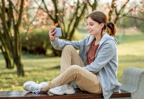 Young Girl Sitting Spring Park Bench Having Video Chat Smartphone — Stock Photo, Image