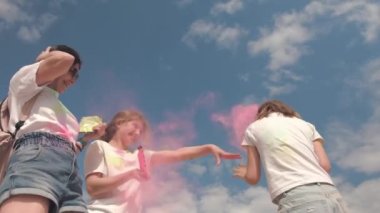 Holi Festivali 'nde kızları olan bir anne Holi tozuyla oynuyor. Birbirlerine renkli pudra kusuyor.