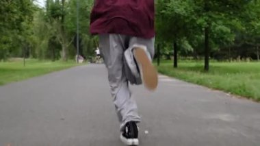 Parkta spor ayakkabılarla koşan kız.