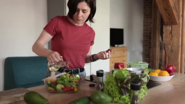 Young Woman Cooking Healthy Vegetable Salad Home Kitchen Adding Healthy — Stock Video