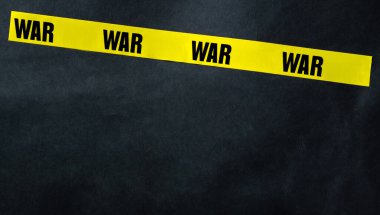 Yellow tape stripe with war text as warning stop millitary conflict. Concept of invasion, danger and truth