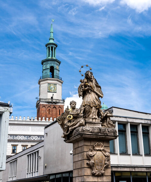 John of Nepomuk Monument on an Old Market Stary Rynek square with small colorful houses and old Town Hall in Poznan, Poland