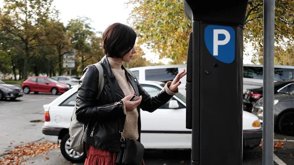 Woman Pays For Car Parking Via Parking Meter Using Credit Card