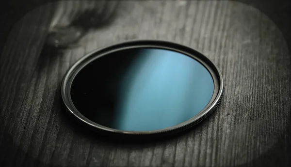 ND filter filter for photo and video shooting on a black wooden table