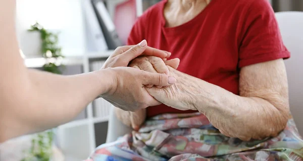 Nurse Soothes Elderly Woman Gently Stroking Her Hands Medical Office — Stock Photo, Image