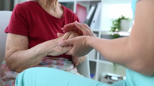 Nurse Soothes Elderly Woman Gently Stroking Her Hands Medical Office — Stock Video