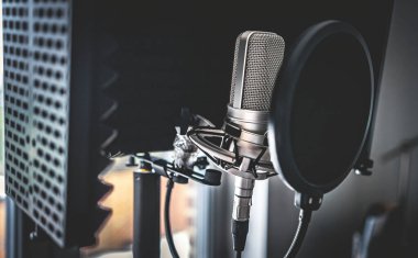 Professional microphone in recording studio for music creation closeup. Mic for rock and pop vocal presentation