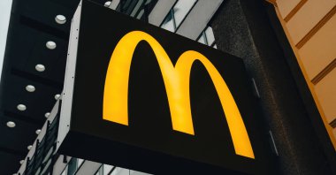 Belin, Germany - 20 December 2022: McDonalds symbol on a board in the city street