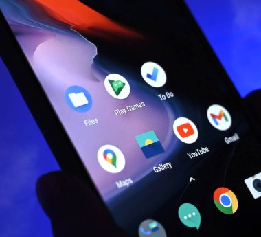 Poznan, Poland - 13 January: Smartphone with apps icons against blue background. Choosing social media application.