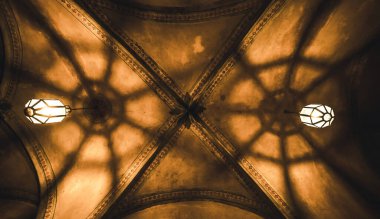 Czech Republic, Krumlov - 21 August 2018: light from the lamp and the shadows in the mysterious arch clipart