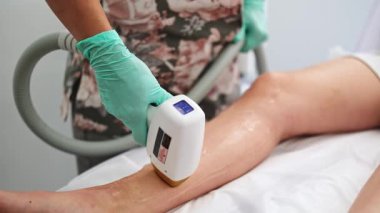 Lazer cihazıyla kozmetoloji kliniğinde lazer tüyü çıkarma prosedürüne tabi tutulan bir kız.