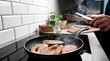 Kızarmış kırmızı balık somonu mutfakta ocakta kızartıyordu. Evde sağlıklı yemekler pişiriyordu.