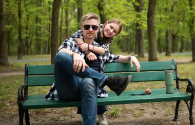 Happy Father And Little Daughter Hugging In Park In Family Look