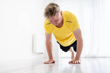 Sporty Young Man Doing Morning Push-Ups As Home Training