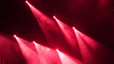 Red Stage Light Shines Through Smoke During A Musical Performance