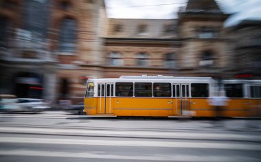 Yellow City Tram Rushes In Motion On A Budapest Street