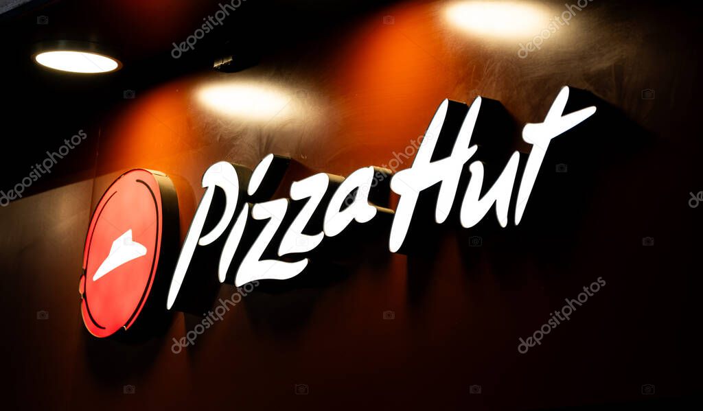 Warsaw, Poland - 29 December 2024: Large Sign With The Pizza Hut Logo At The Entrance Lighting At Night
