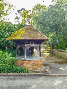 Sandhurst old water well. No longer in use. Made of brick, wood and tile.  clipart