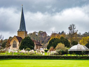 Church of St Peter and St Paul, Godalming. Surrey UK. With bowling green and a bandstand.  clipart