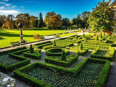 Formal Gardens of South Hill Park Bracknell Berkshire on a sunny autumn day. Showing maze of small hedges. clipart