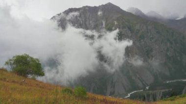 The movement of clouds in a mountain valley. Rainy weather high in the mountains. Tien Shan mountain system. Kazakhstan