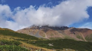 The movement of clouds over a mountain peak. Timelapse. Tien Shan mountain system. Kazakhstan