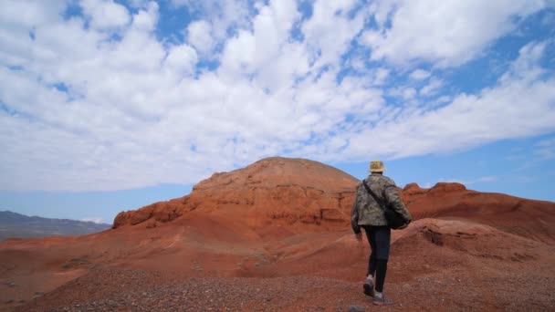 Turista Entra Num Desfiladeiro Rochas Vermelhas Invulgares Montanhas Rochas Arenito — Vídeo de Stock