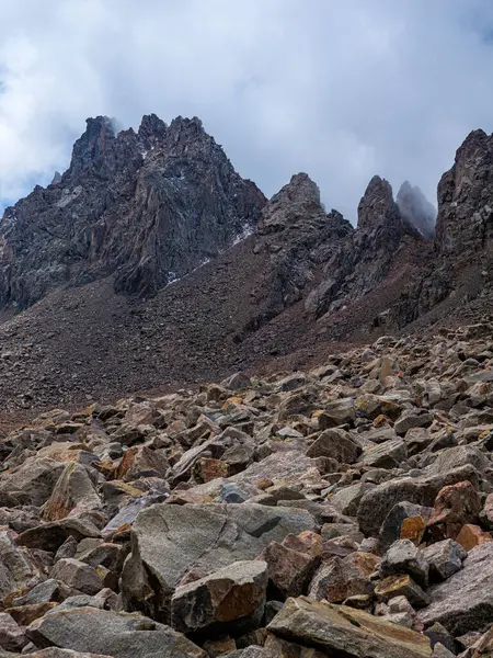 stock image Impregnable cliffs peek out of the clouds. Stony cliffs high in the mountains. Talgar Pass