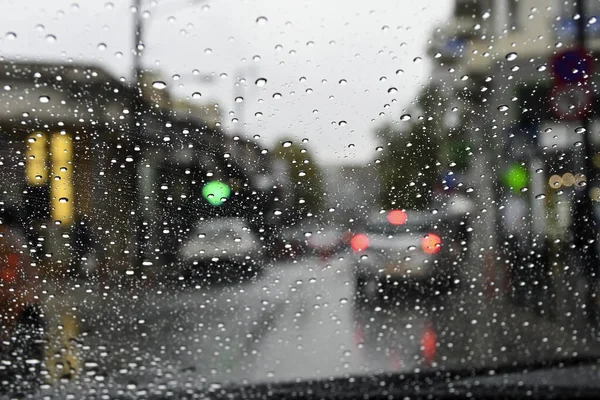 driver\'s view of the city on a rainy day