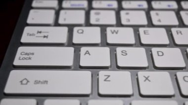 sliding footage of white keyboard of laptop closeup