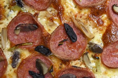 mozzarella, pepperoni, mantar ve zeytinli özel pizza.