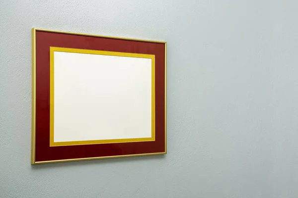 modern blank picture frame on light blue wall