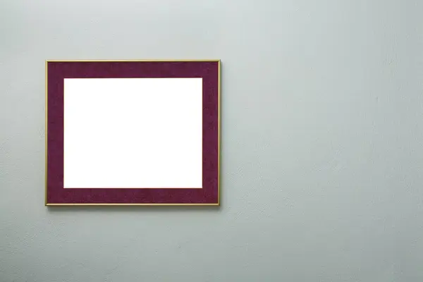 modern blank picture frame on light blue wall