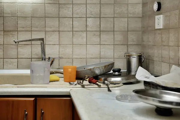 messy kitchen counter with a variety of kitchen utensils
