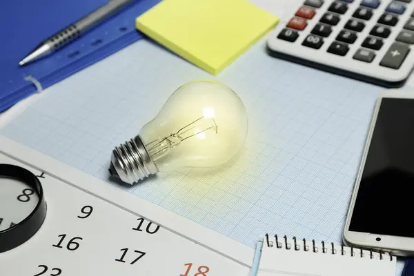 Lit Light Bulb Desk Business Concept Stock Photo