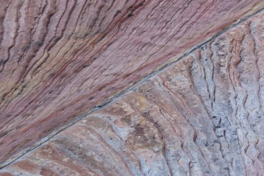Layers of ancient sandstone rock in pastel colors in Zion National Park, Utah. Background.