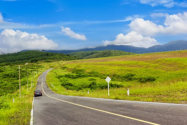 stock image Car road and Green grass with blue sky at Klong Haeng Reservoir Krabi, Thailand