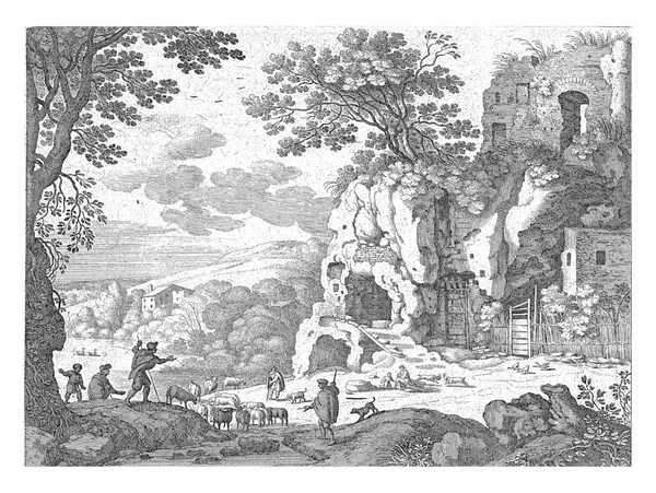 几个牧羊人带着羊群和狗在岩石上的废墟前散步 左边后边的一个湖 — 图库照片