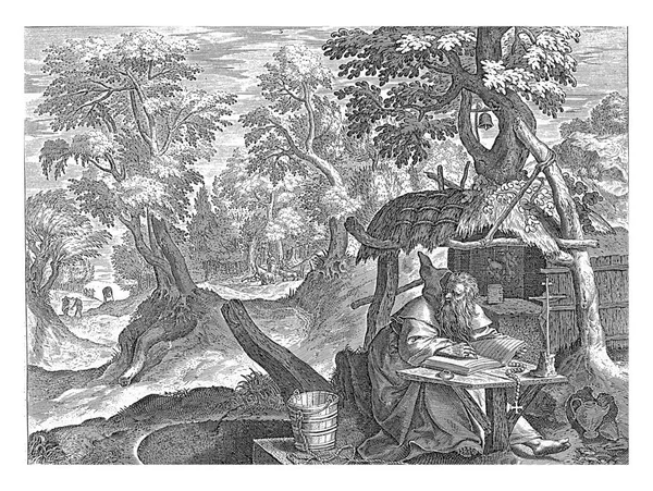 テオナスは荒野の洞窟で隠者として 彼は作業台の前に座り 聖書を読みます 背景に乞食のいる風景 — ストック写真